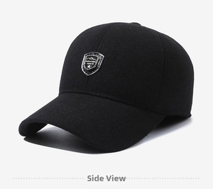 Detailed view of black winter baseball cap featuring a silver shield sport emblem