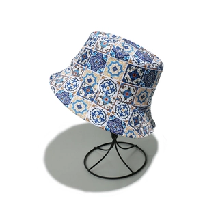 Detail of bohemian bucket hat with vintage blue tile patterns on a metal stand