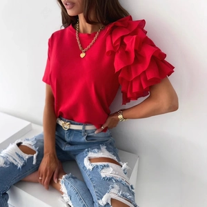 Women's red ruffle sleeve t-shirt paired with light blue distressed jeans and necklace