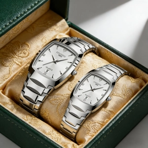 Close-up of KINGNOS silver quartz couple watches in a luxury green gift box