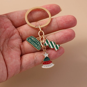 Christmas keychain with Merry Christmas plate, candy cane and tree on a gold ring