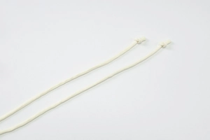 Detail of beige halter fabric ties with simple end knots on a sleek mesh printed dress