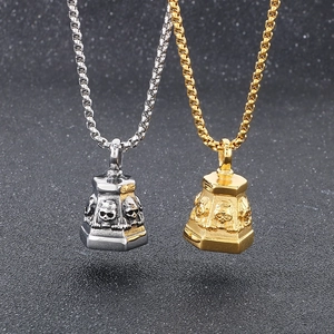 Close-up of gold and silver gothic skull bell pendants on round box chains