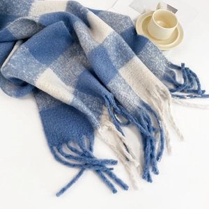 Detail of blue and white checkered mohair scarf with soft fringes and warm texture