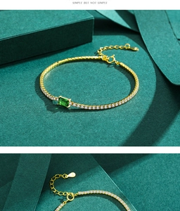 Detail of gold chain bracelet with emerald-cut green stone and sparkling zircon pavé