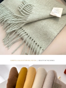 Detailed macro view of 100% Australian wool scarf featuring soft tassels and laundry tag