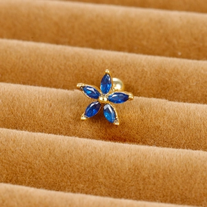Macro detail of royal blue marquise zircon flower stud with golden screw back
