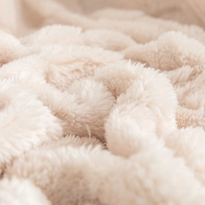 Thick checkered fleece blanket in cream white showing soft plush fiber texture