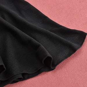 Macro shot of black ribbed knit fabric texture with soft drapery for a mini dress