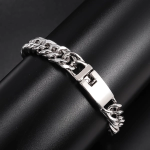 Polished silver cuban link bracelet for men with secure square clasp on black display