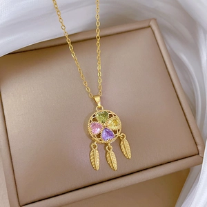 Luxurious gold clover dreamcatcher necklace with colorful heart gems and feather charms