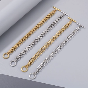 Detailed macro view of gold and silver cuban link bracelets with industrial OT toggles