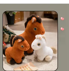 Detail of plush horse toys in brown and white with sunflower eye patterns and soft texture