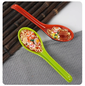 Detailed realistic food model of beef noodles with egg and shrimp in a colorful spoon