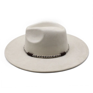 Close-up of beige suede fedora featuring a textured black and white woven hat band
