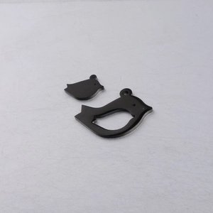 Macro detail of bird-shaped stainless steel charms with a polished black mirror finish