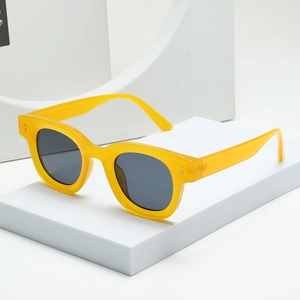 Retro vintage oval sunglasses with yellow frames and black lenses on white pedestal