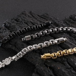 Hip hop skull steel bracelets in gold silver black and antique finishes on dark wood