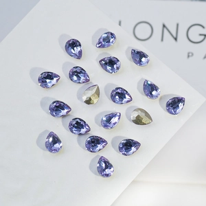 Macro view of teardrop K9 crystals in lavender purple with golden accent details