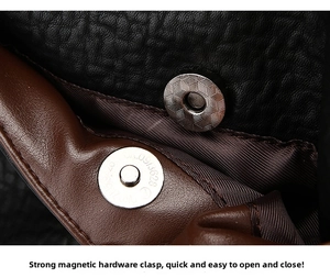 Detail of metal magnetic clasp on a premium black and brown elephant grain leather bag