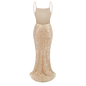 Detail of elegant champagne evening dress with sequin fishtail hem and slim straps