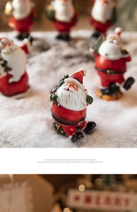 Group of festive Santa Claus figurines on artificial snow for Christmas table decoration