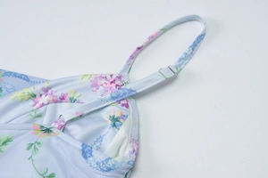 Macro detail of adjustable straps and floral fabric on a summer backless dress