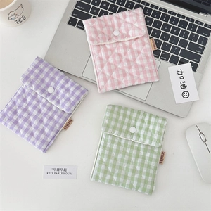 Detail of quilted macaron storage pouches with snap closure for small accessories