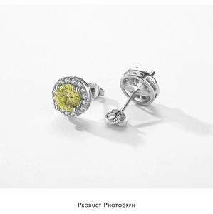 Macro detail of S925 sterling silver stud earrings with a central yellow gemstone halo