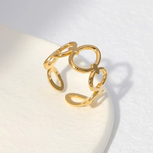 Macro shot of adjustable gold stainless steel ring with geometric chain design