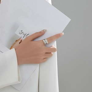 Minimalist silver lava irregular geometric wide ring on female hand in a stylish setting