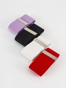 Detailed close-up of elastic waist belts with silver rectangular buckles in four colors