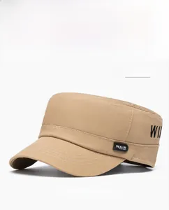 Close-up of khaki flat top cap showing cotton twill texture and side embroidery details