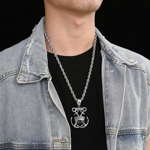 Detailed view of silver skipper anchor and swords pendant with twist chain on a model
