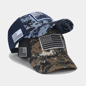 Close-up of tactical camo mesh baseball caps with American flag patches on white background