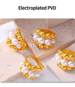 Detail view of multi-layer gold PVD plated ring with beads and pearls on stone base