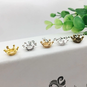 DIY crown alloy jewelry accessories in five colors displayed on a white stand