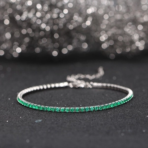 Detailed close-up of 925 sterling silver bracelet with sparkling green zircon stones