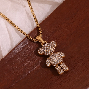 Close-up of a 3D gold-plated bear pendant encrusted with sparkling rhinestones on a chain