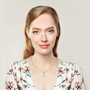 Detail showing an 18K gold stainless steel necklace with round letter B shell pendant