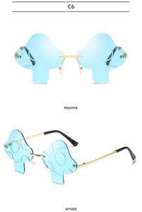 Detail view of mushroom-shaped rimless sunglasses with blue lenses and gold metal temples
