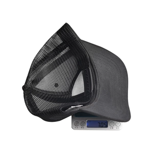 Detailed top view of a black mesh baseball cap on an electronic scale showing 70.5g weight