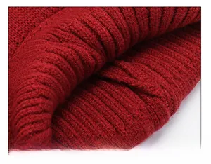 Close-up of premium rib-knit texture and precise stitching on the red winter beanie hat
