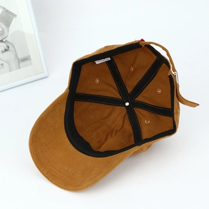 Interior view of brown cotton baseball cap showing black sweatband and metal buckle