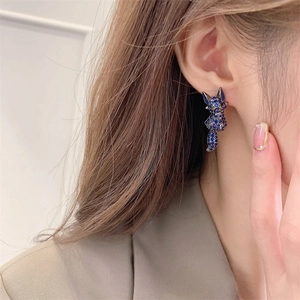 Exquisite fox stud earrings with blue crystals shown on model in a professional close-up