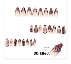 Dettaglio di 24 unghie finte mandorla 3D con decorazioni di ciliegie, fiocchi e tigre