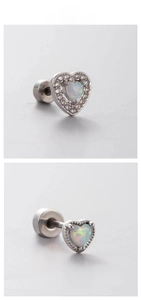 Detailed view of silver heart opal stud earrings with sparkling halo setting