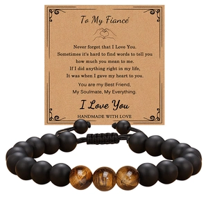 Detail of tiger eye bead bracelet on message card for fiancé with adjustable cord