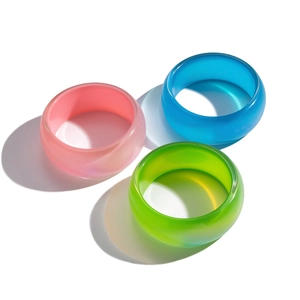 Colorful pearlescent resin bangles set in pink blue and green with wide geometric design