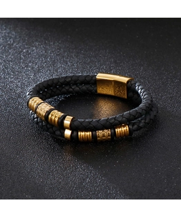 Detailed macro view of black braided leather multi-layer bracelet with gold metal magnetic clasp